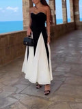 Robe longue bustier noir et blanc, idéale pour soirée élégante ou plage, avec sac à main et sandales