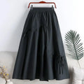 Jupe longue noire taille élastiquée avec poches et liens, style féminin élégant pour toutes les occasions