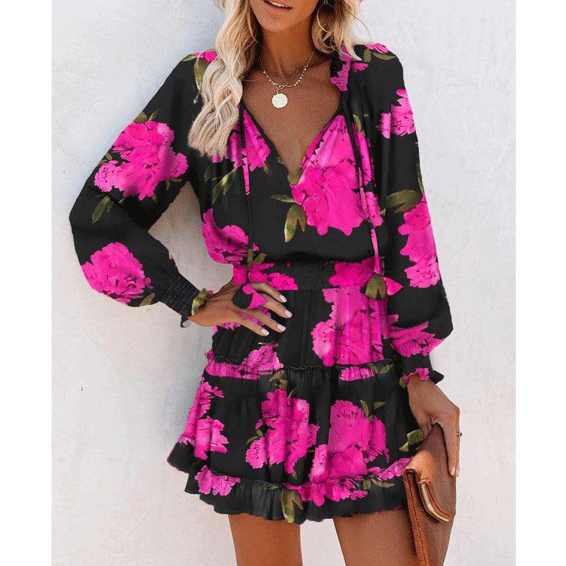 Robe bohème noire à fleurs roses vives, manches longues et décolleté en V pour une mode féminine élégante
