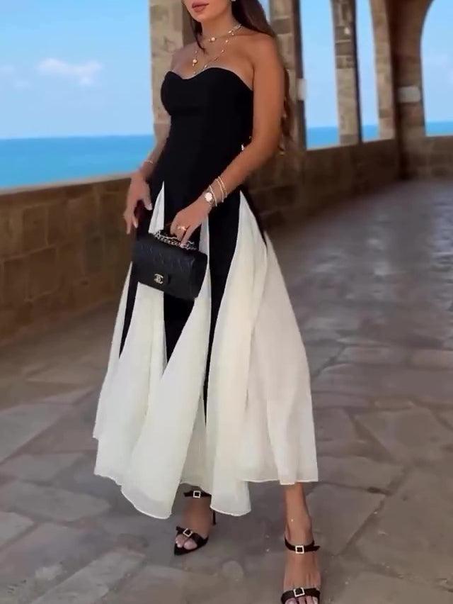 Robe féminine noire et blanche à bretelles fines, idéale pour les occasions élégantes près de la mer
