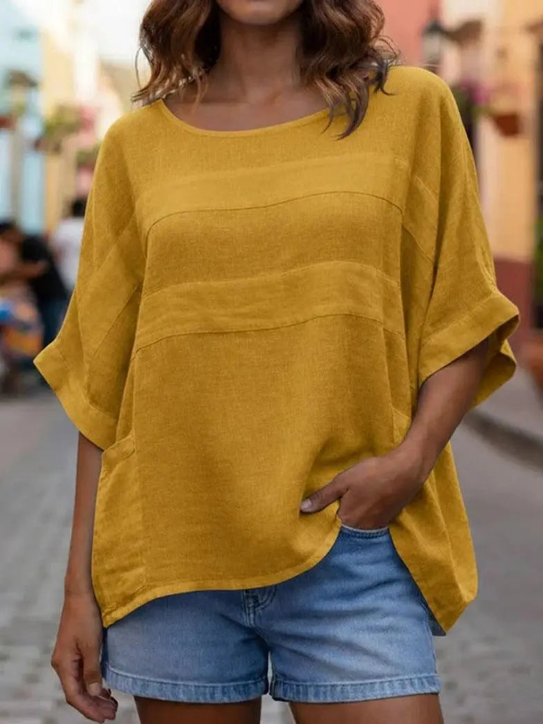 Top féminin jaune moutarde ample avec poches, idéal pour une tenue décontractée et tendance